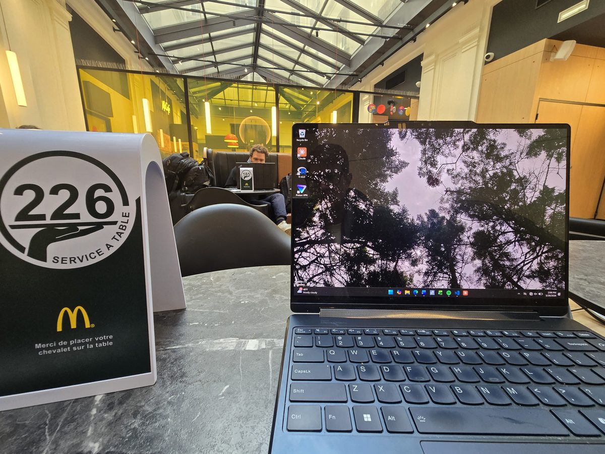 A laptop open at a McDonald's table inside Bordeaux train station, order number 226 visible