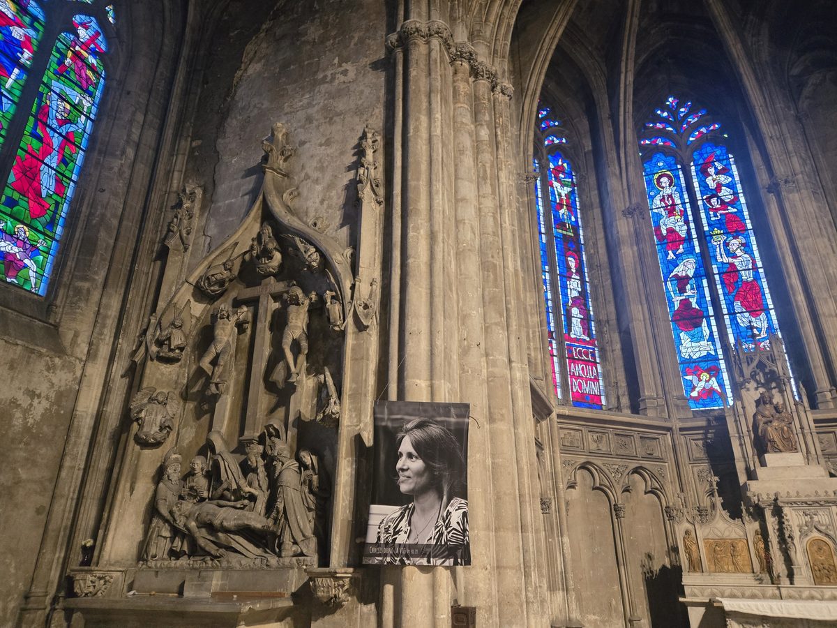 A religious statue against dark stone inside Saint-Michel