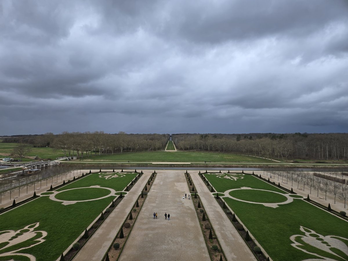 Chambord&rsquo;s formal gardens seen from the rooftop — geometric patterns stretching to the horizon