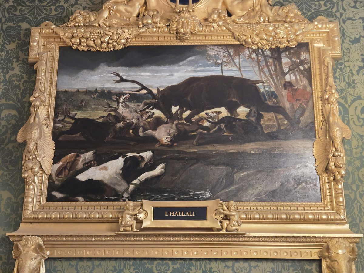 An ornate hunting scene painting at Chambord
