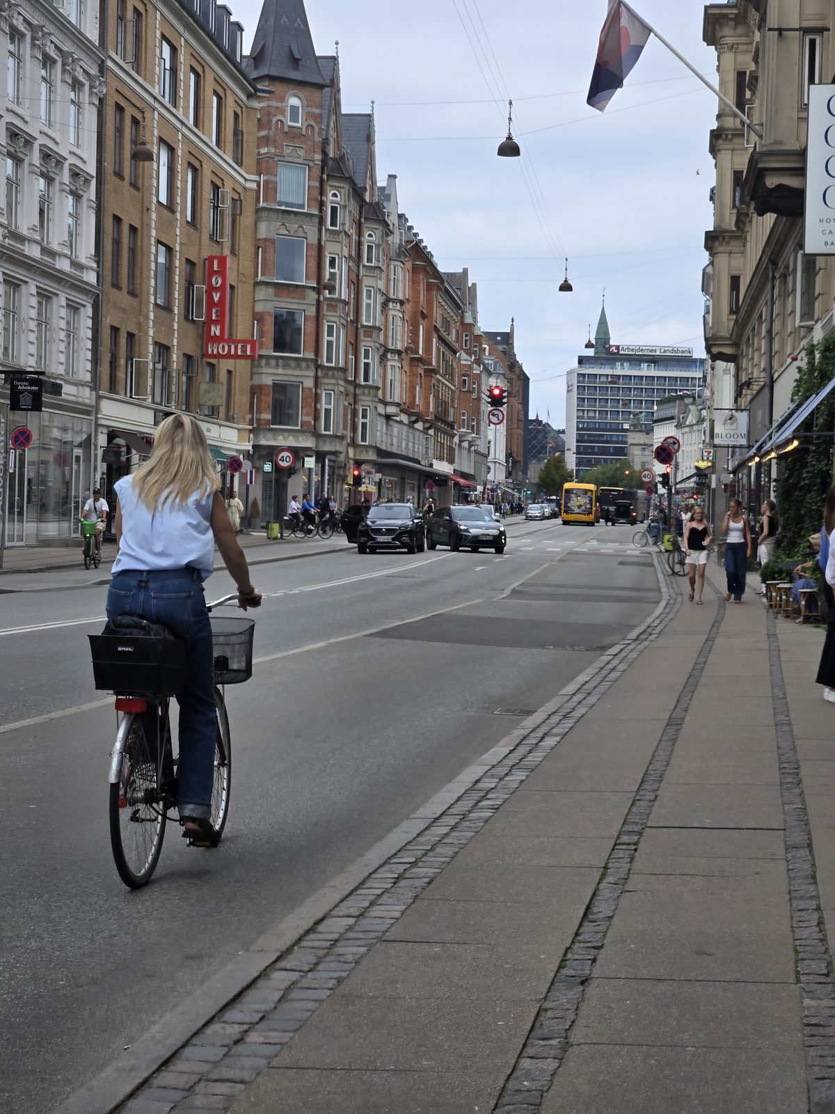 A Copenhagen street with historic townhouses and a cyclist