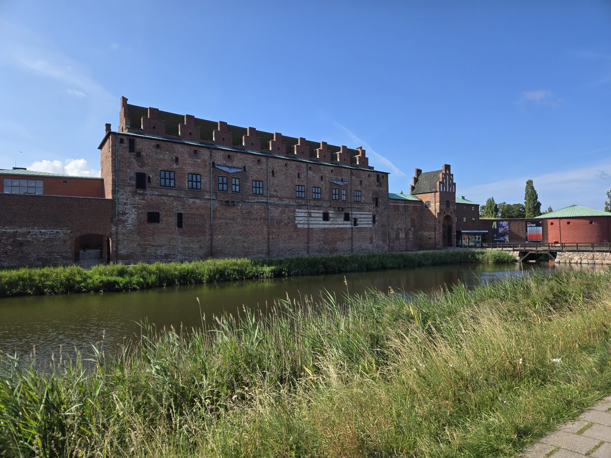 Red-brick building reflected in the Malm&ouml; Castle moat