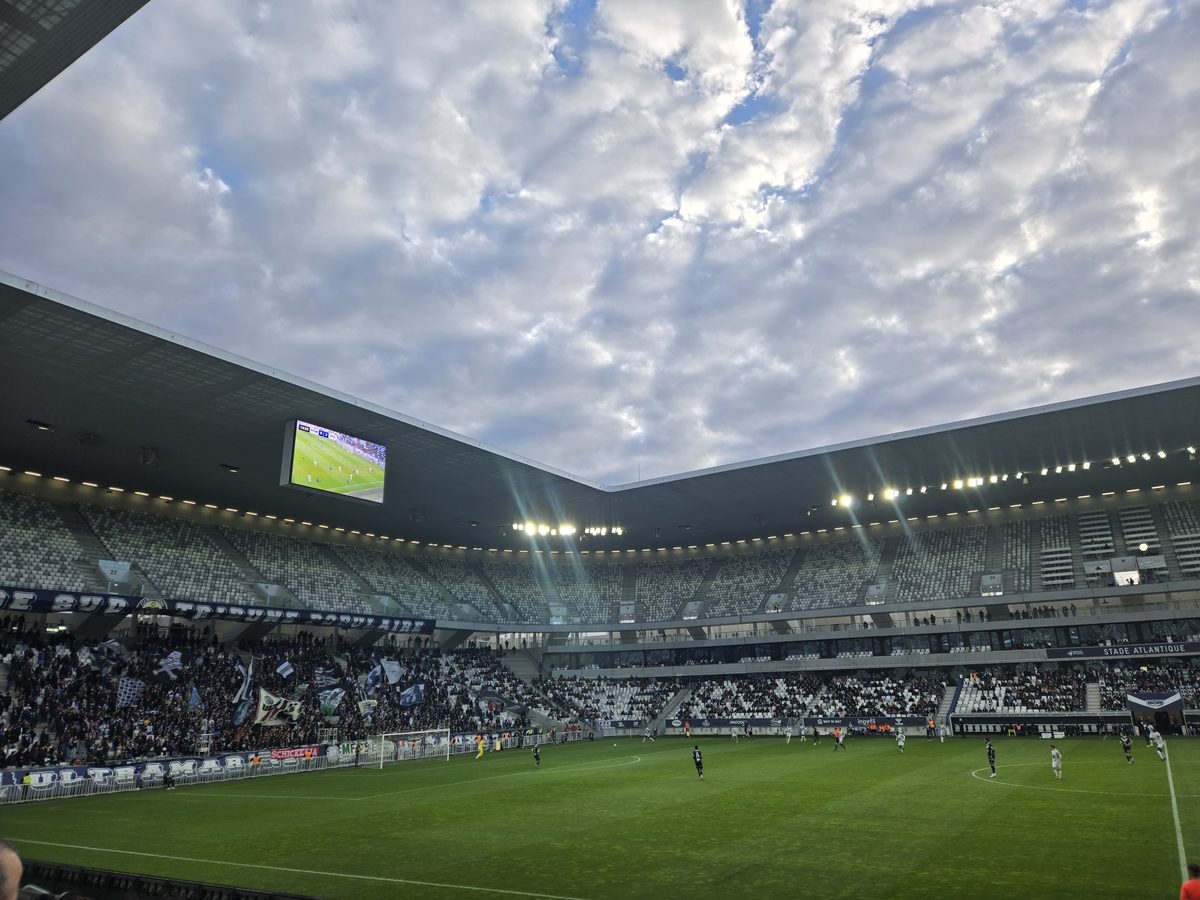 The pitch and mostly empty upper stands under the lights