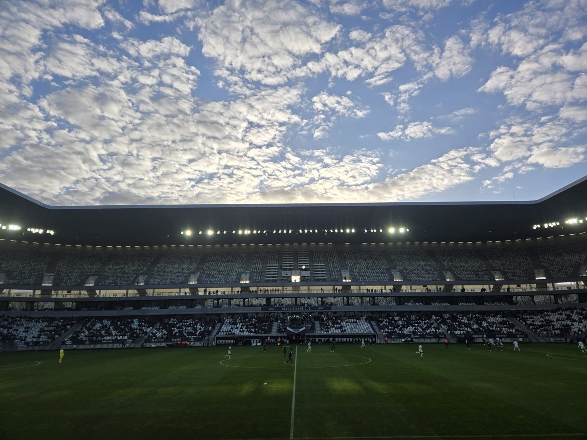 Match action under clearing skies in the mostly empty Stade Atlantique
