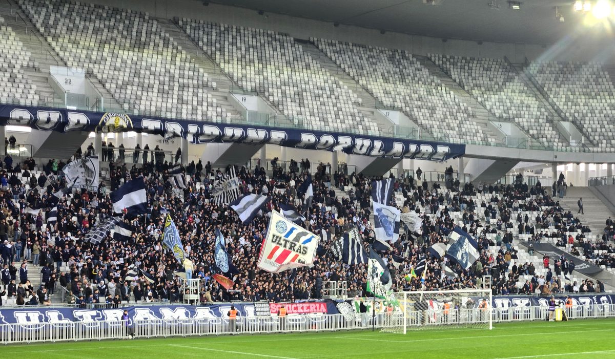 The ultras section with blue and white flags flying