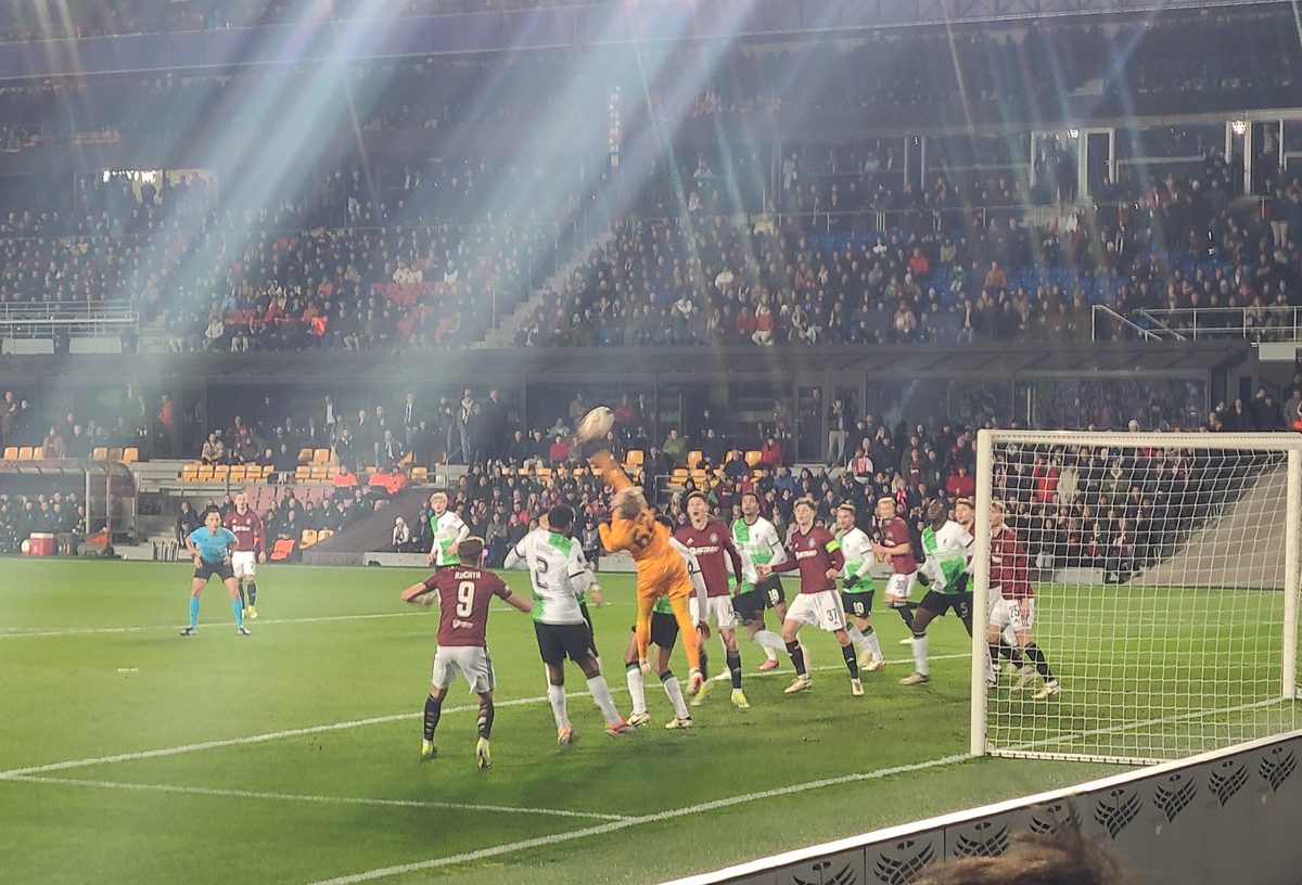 Corner kick action under the floodlights